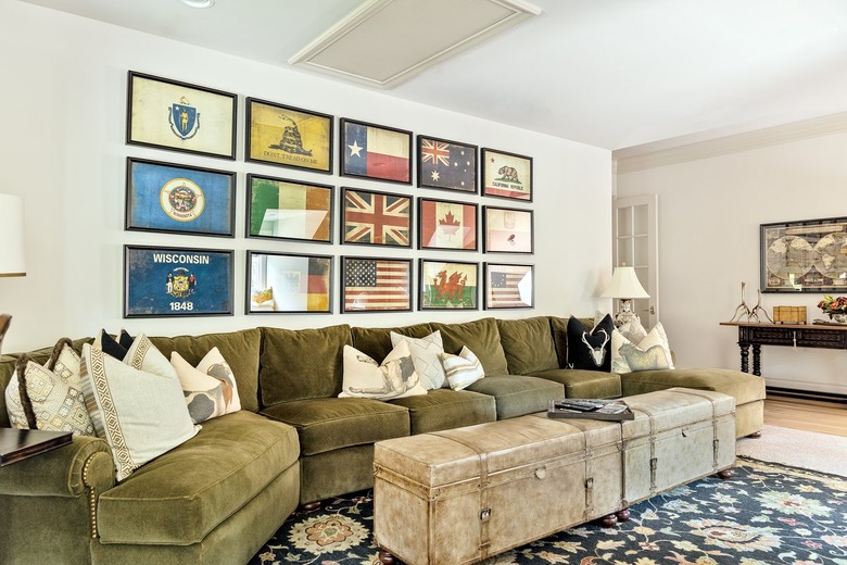 living room featuring an olive green couch and beige walls