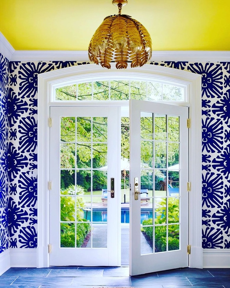 foyer with navy blue and white wallpaper