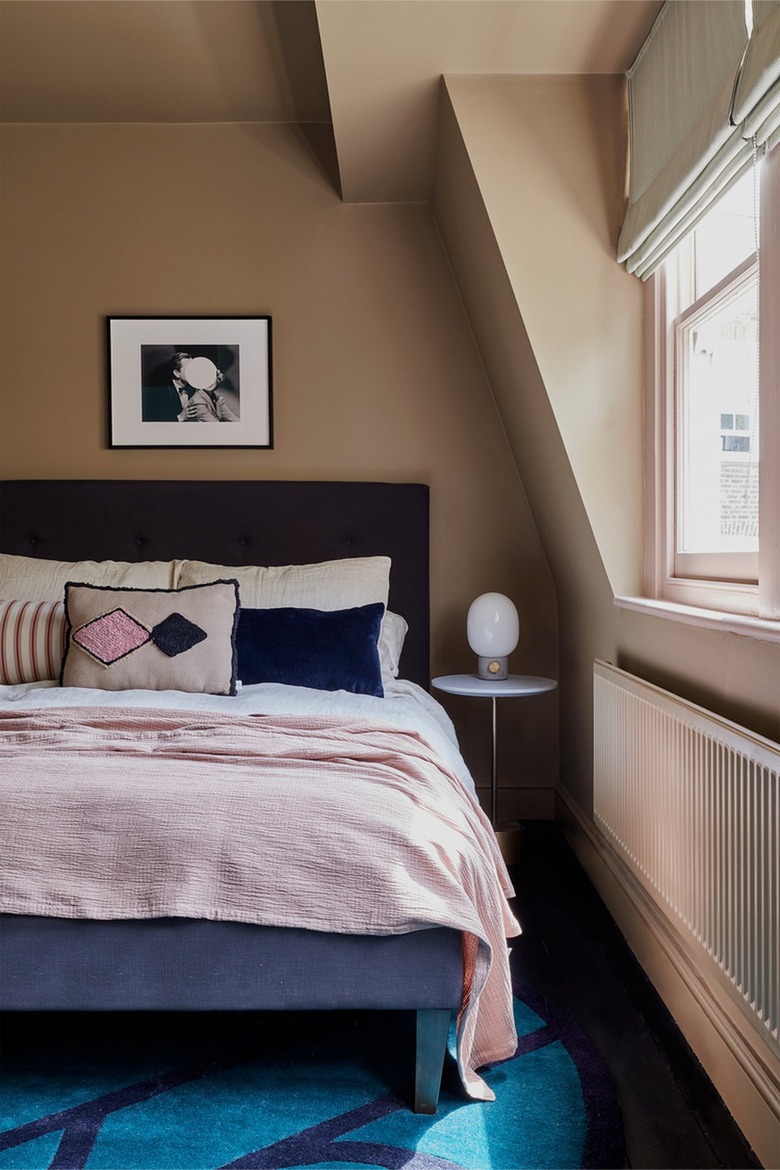 bedroom with taupe walls and navy bed
