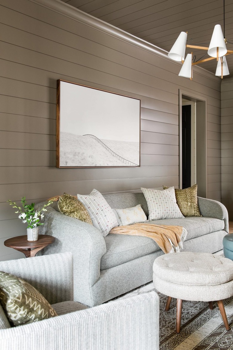 living room with taupe walls and greige sofa