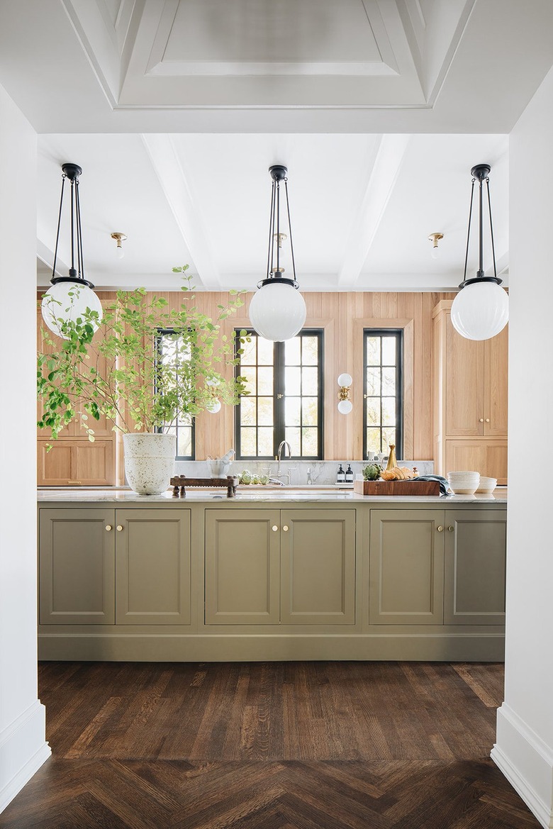 kitchen with wood walls and taupe cabinetry