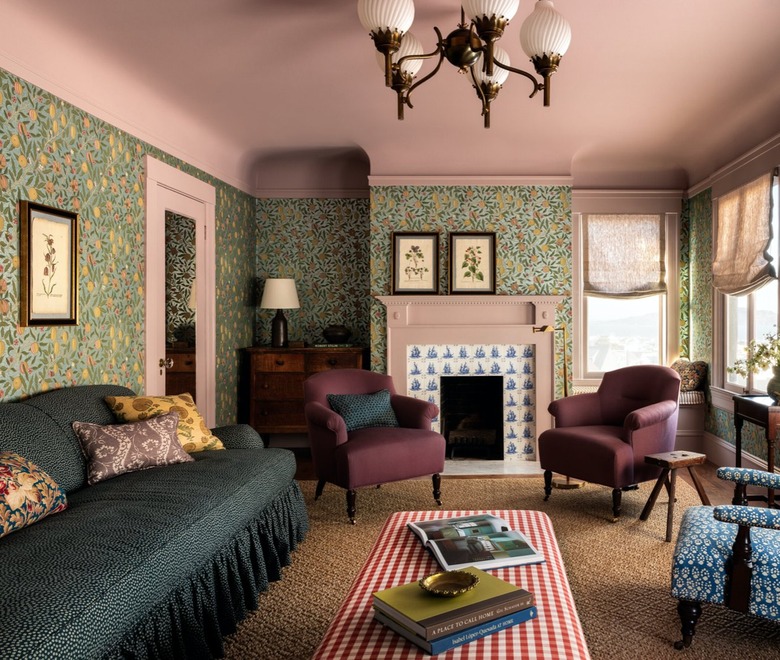 living room with pink ceiling/fireplace surround and green wallpaper