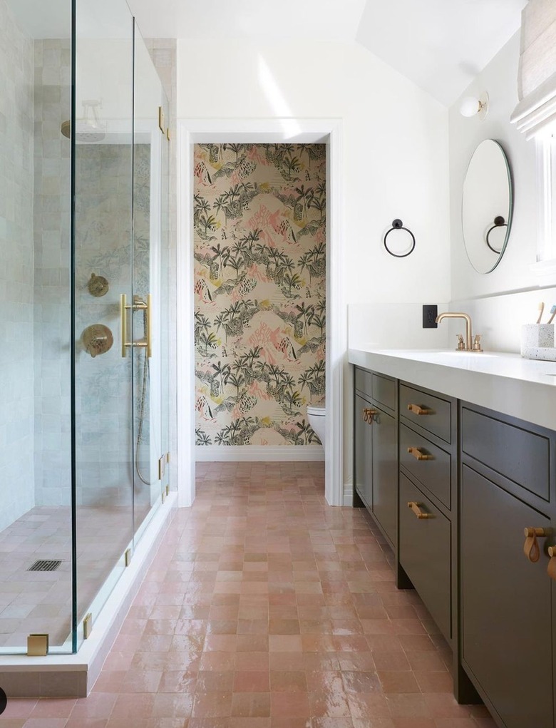bathroom with pink zellige floor tile and olive green vanity
