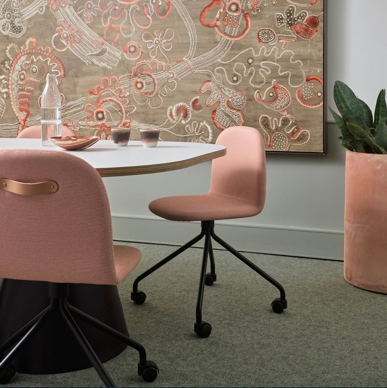 conference room with pink chairs and taupe and pink artwork