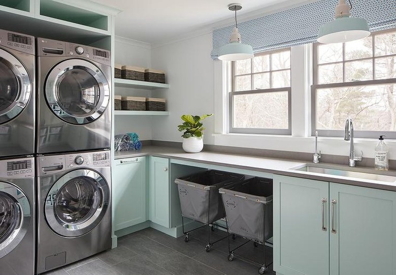 laundry room with mint green cabinets