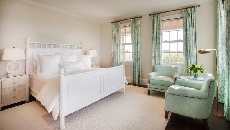 traditional bedroom with tan walls and mint green accents