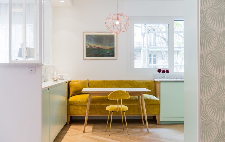 mustard yellow seating with mint green cabinets