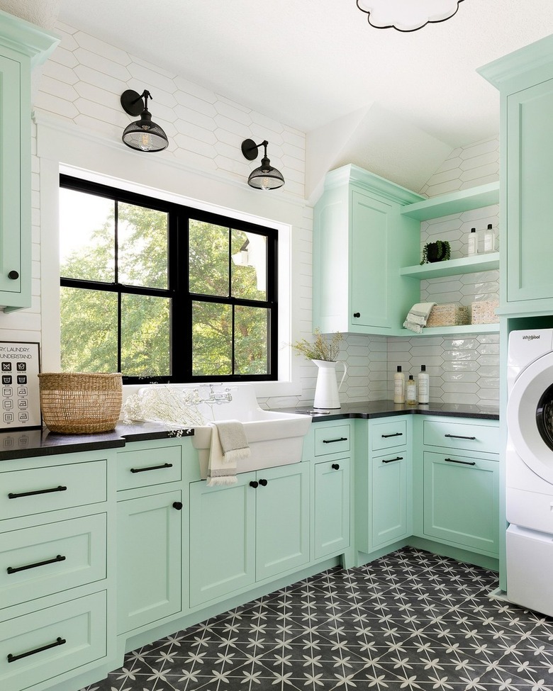 mint green laundry room with black hardware