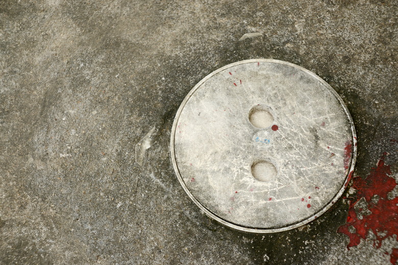 PVC. Floor cleanout on cement floor.