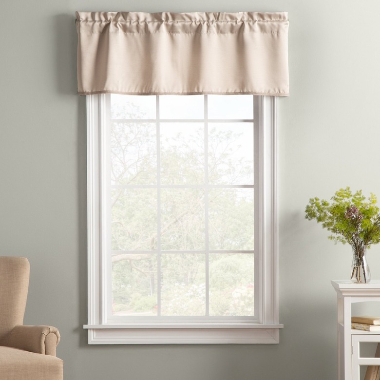 A taupe window valance hung on a window