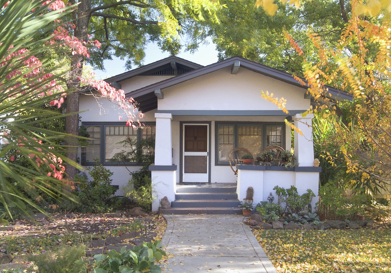 Front exterior of a white bungalow with blue trim