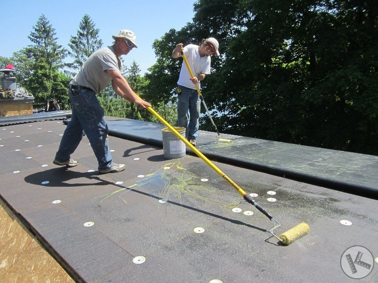 Installing undercoating for TPO roof.