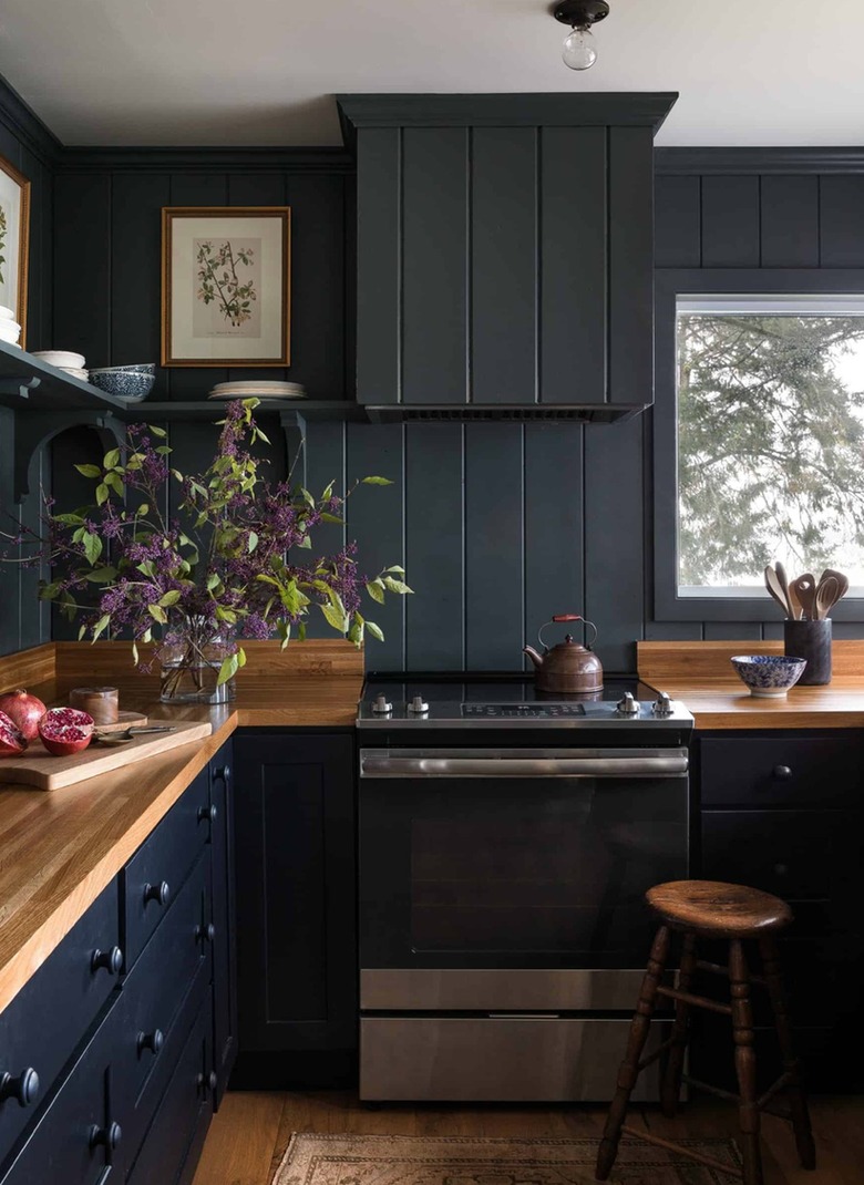 Kitchen with black cabinets and black shiplap backsplash.