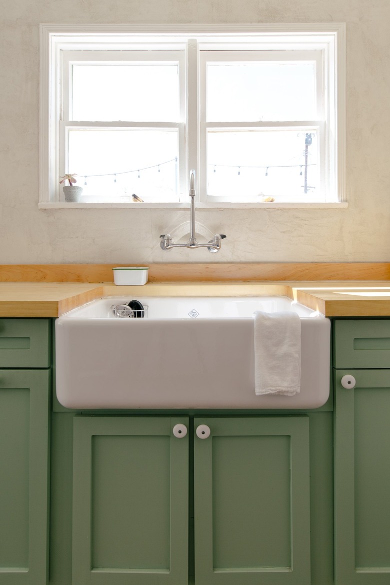 a kitchen includes a deep porcelain sink