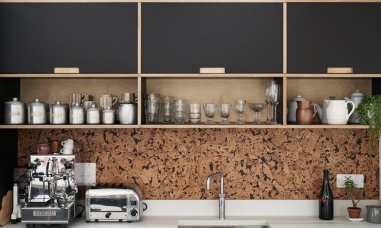 Modern kitchen with black cabinets a cork backsplash