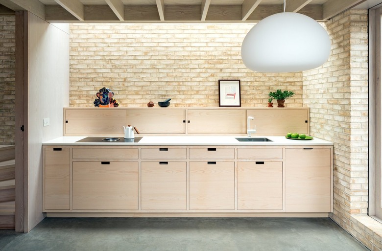 Modern kitchen with light wood cabinets and backsplash