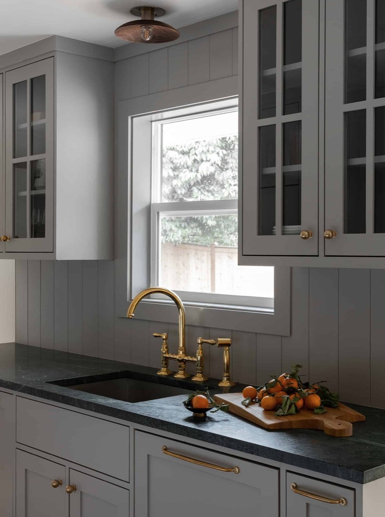 Gray kitchen cabinets with matching gray shiplap backsplash