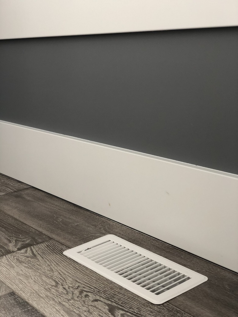 Floor vent next to floor boards