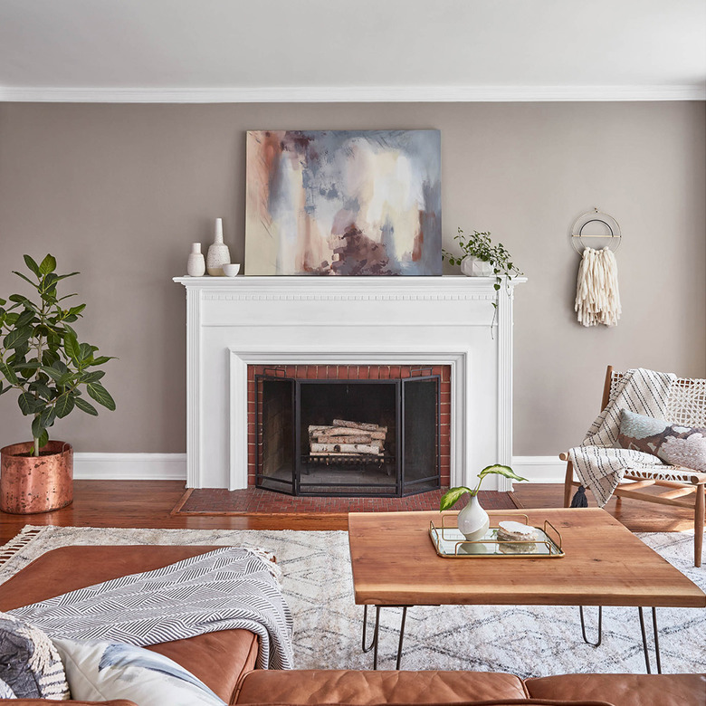 living room with beige wall and white fireplace