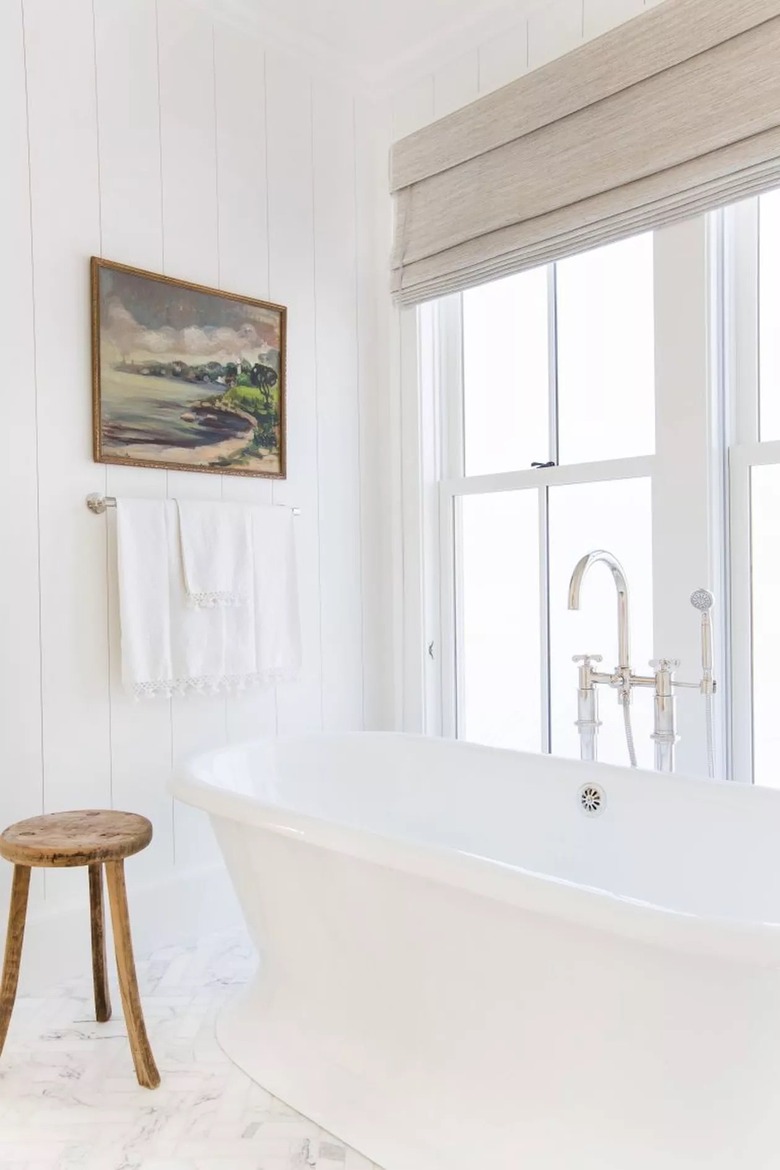 Stark white bathroom with nature portrait