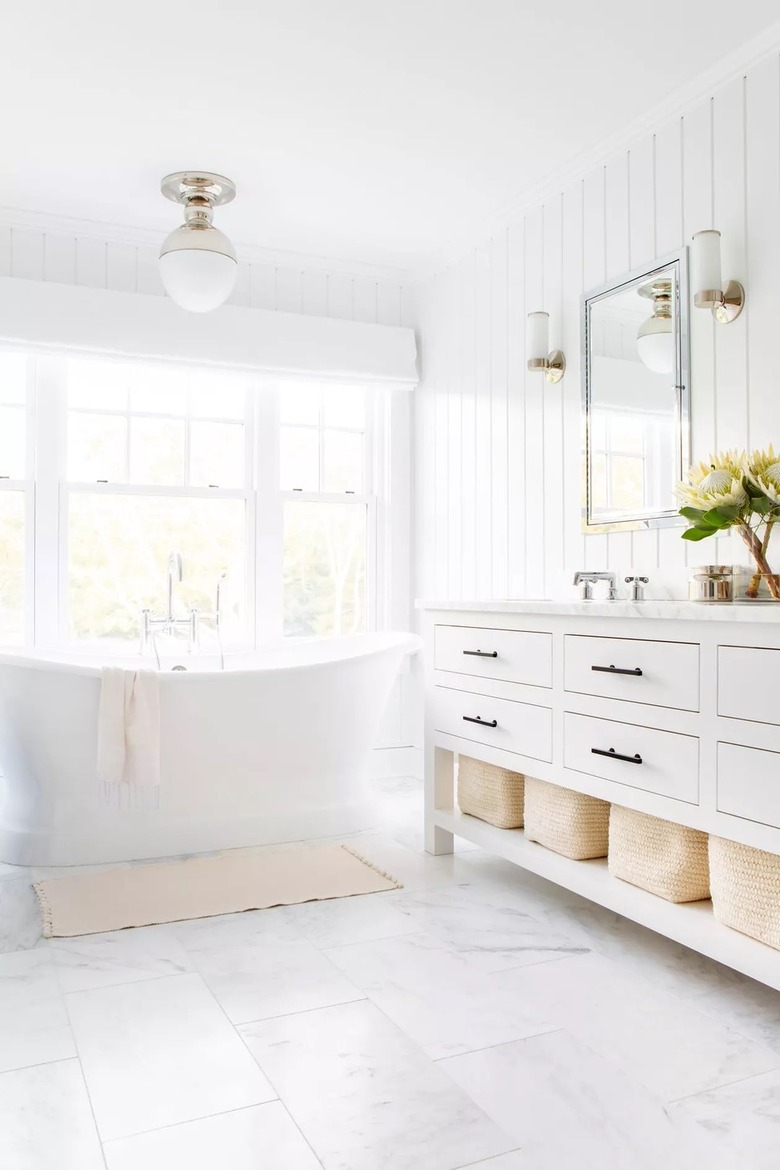 White bathroom with club tub and white vanity