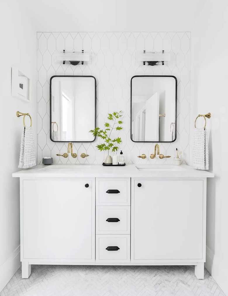 White bathroom vanity with two black mirrors