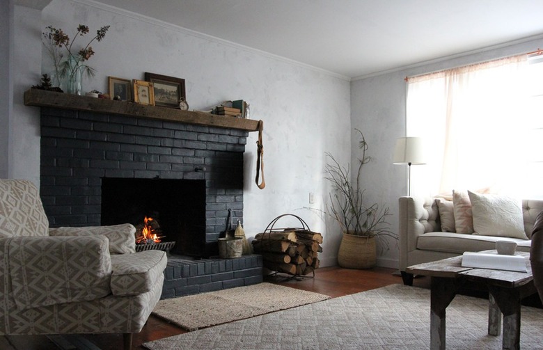 white living room with black brick fireplace surround