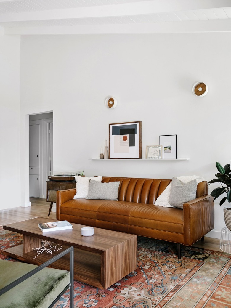 white living room with leather sofa and geometric accents