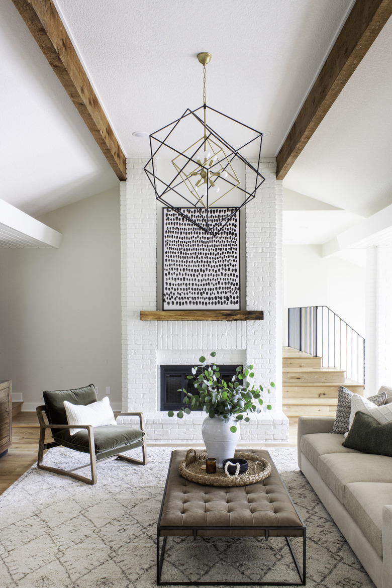 white living room with chandelier and artwork