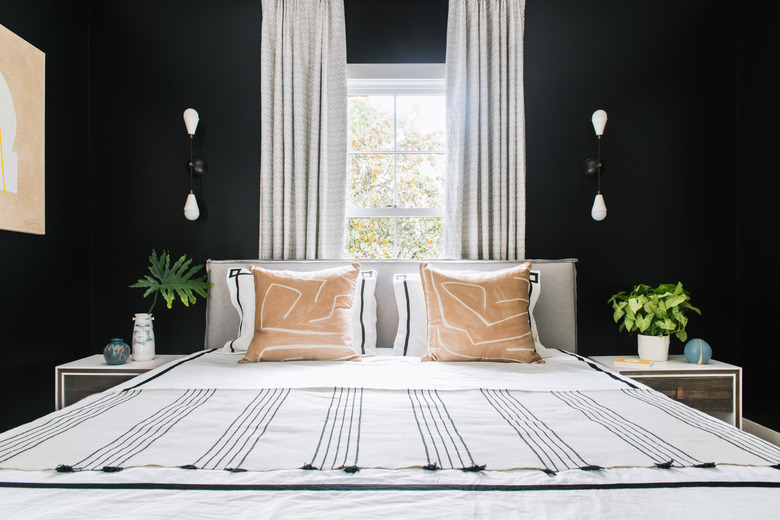 black bedroom with modern sconces