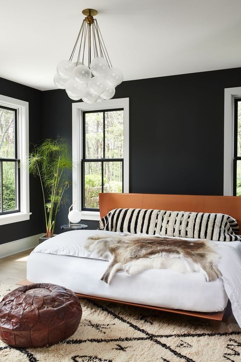 bedroom with black walls and platform bed