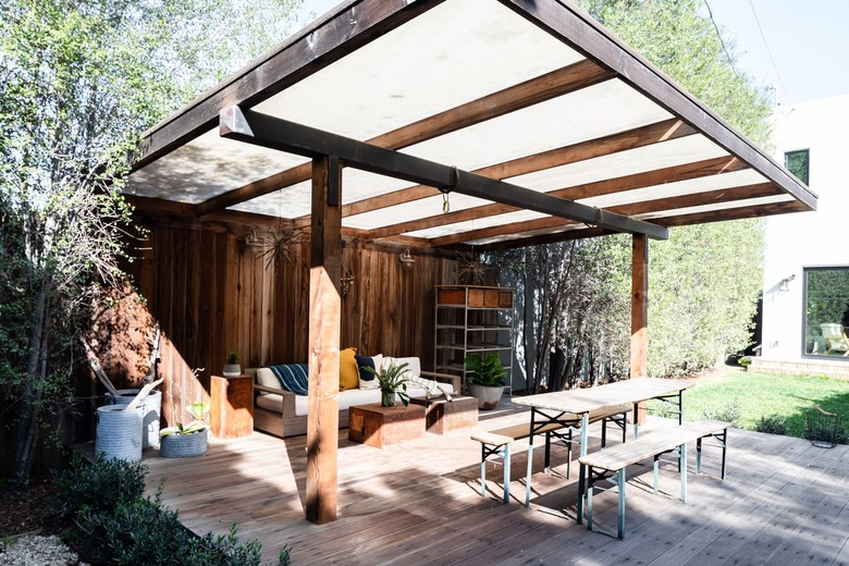A wood pergola with wood flooring