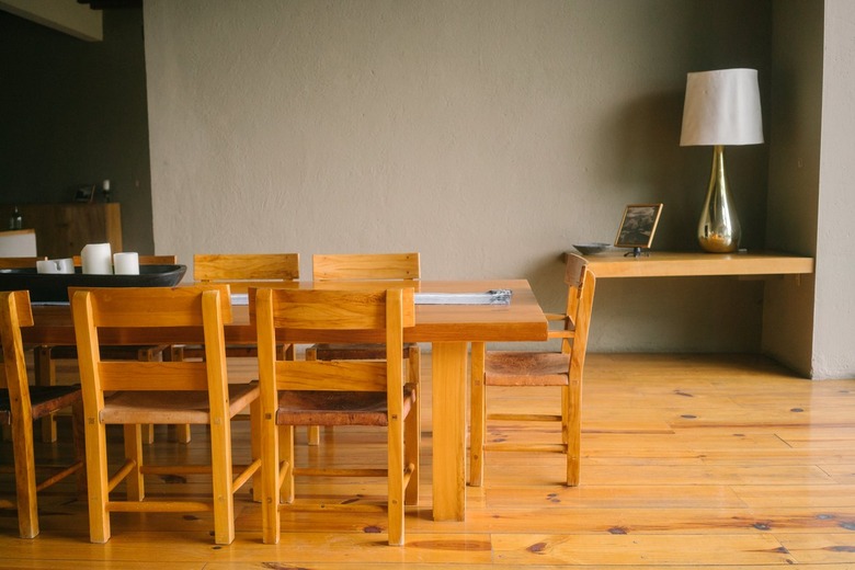 Mid-Century wood dining table set on wood flooring