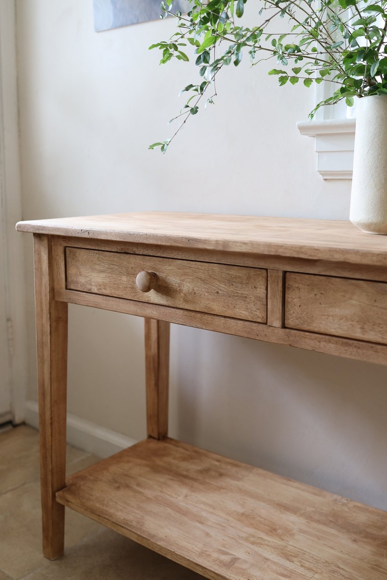 Close up view of distressed wood console table