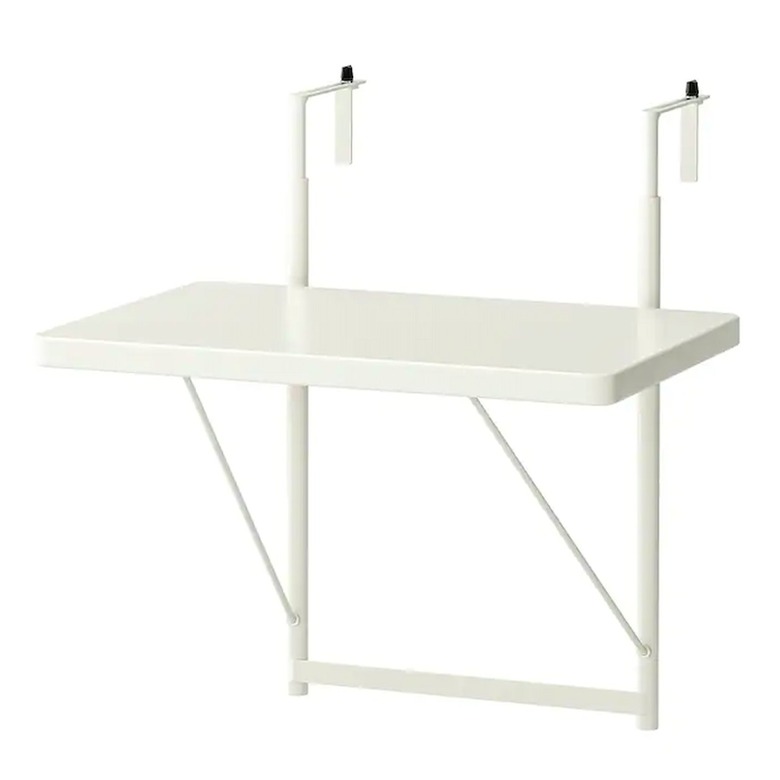 A white balcony table that hooks onto a railing