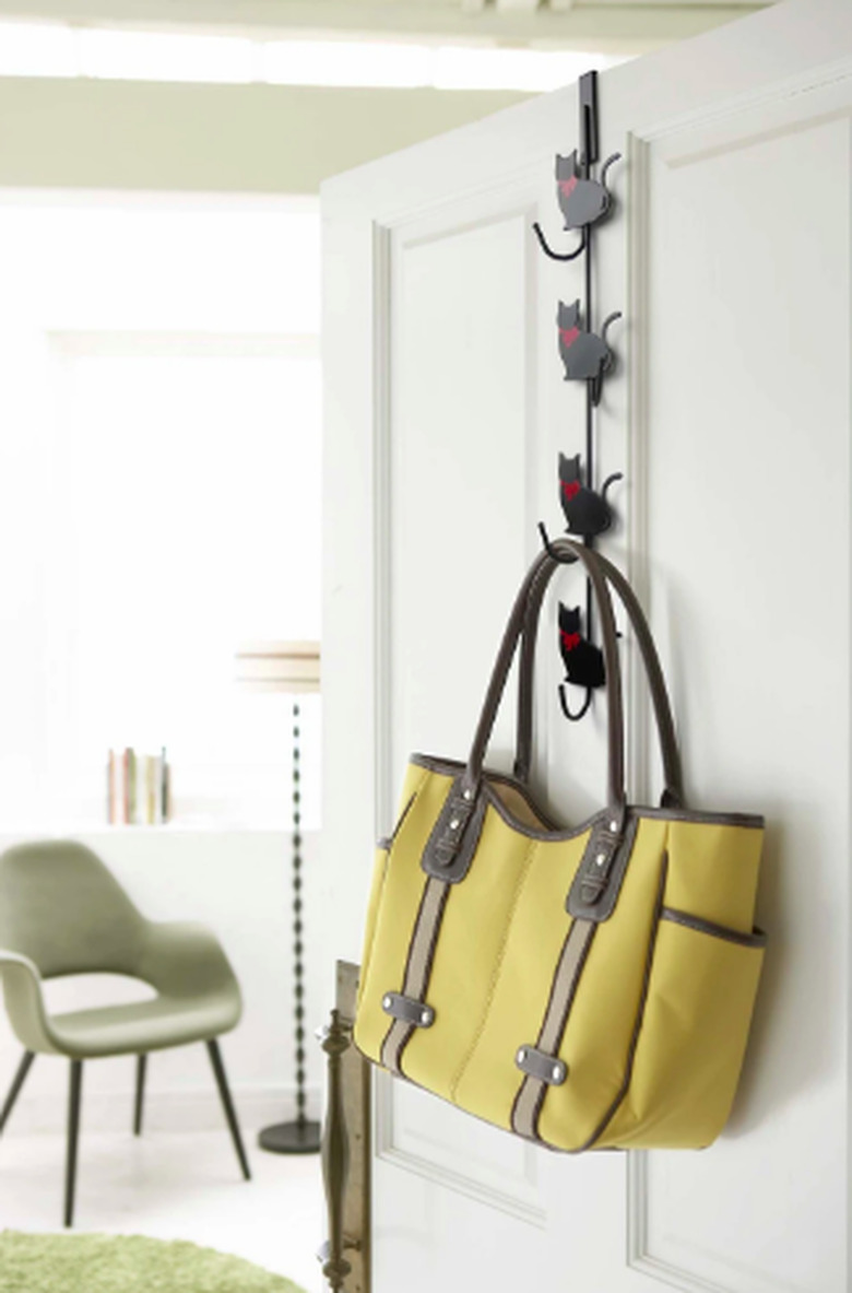 open door with cat hook and purse hanging