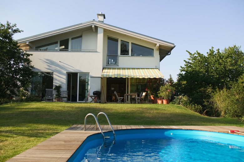 Swimming pool in front of two storey house