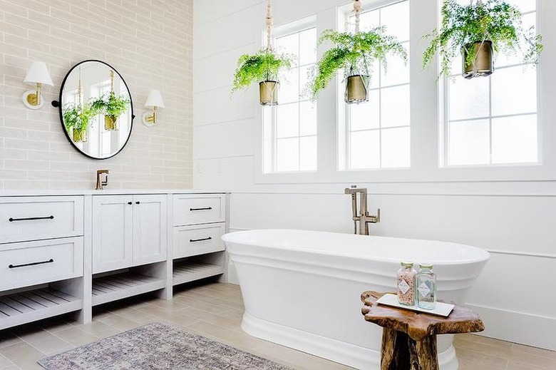 bathroom with hanging plants over the tub