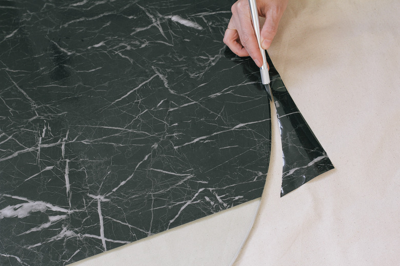 Cutting off excess contact paper