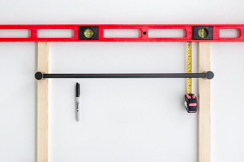 Wood boards with black towel rods with sharpie