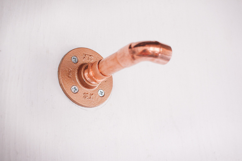 Male adapter screwed into flange on wall