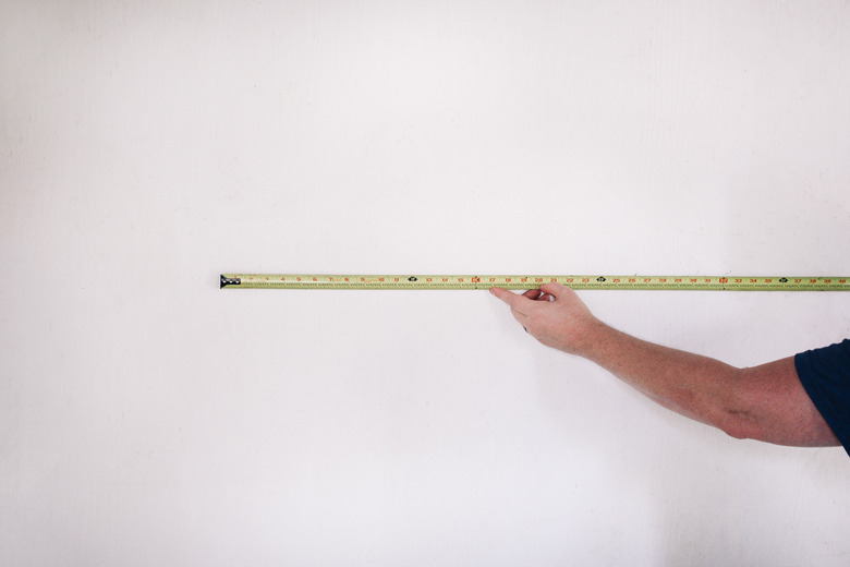 Measuring length of garage wall with tape measure