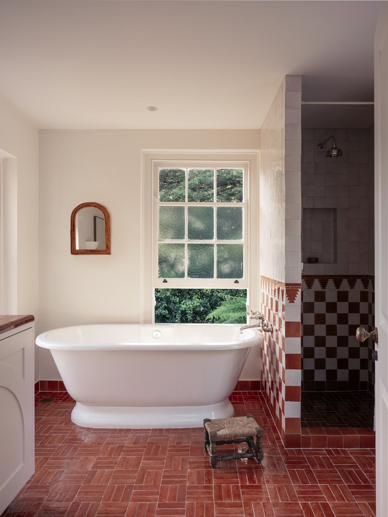 red and white bathroom with freestanding tub