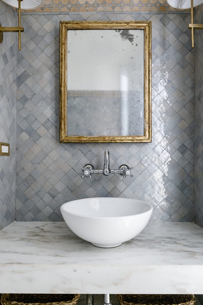 bathroom with blue gray zellige tiled backsplash with traditional mosaic border