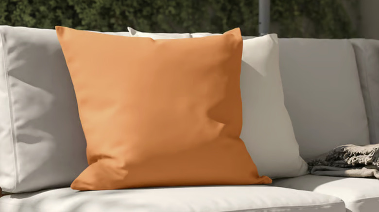 A set of covered cushions on an outdoor couch