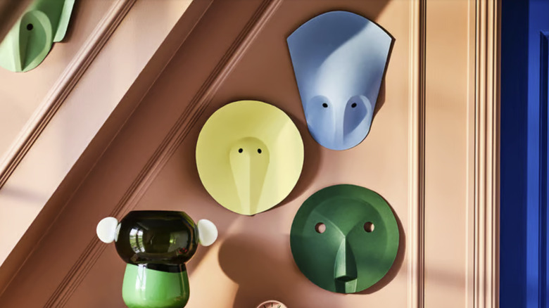 Funky mask-like wall art with pastel colors