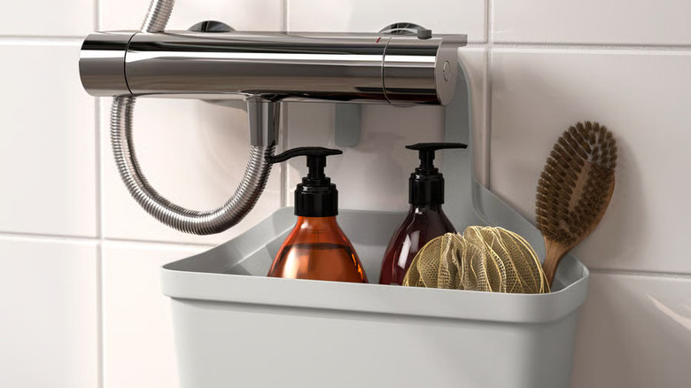 Shower toiletries are stored in a gray hanging shower basket from IKEA