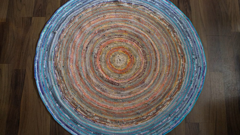 A round rug made from old clothing strips