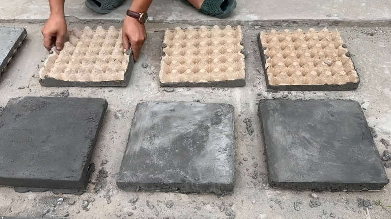 Six concrete tiles made using cardboard egg cartons