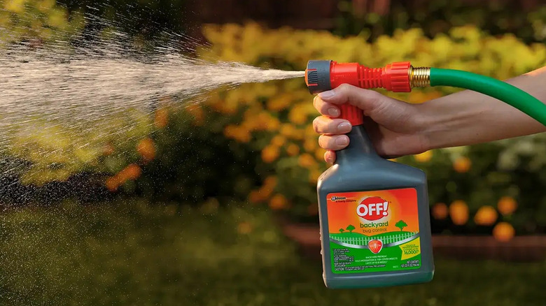 A person sprays Off! Backyard Bug Control in a colorful yard